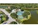 Aerial image of community amenities including pool, tennis court, and basketball court by a lake at 5018 Hanging Moss Ln, Sarasota, FL 34238