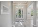 Bright foyer with an elegant tray ceiling, beautiful chandelier, and a clear view of the front yard at 5018 Hanging Moss Ln, Sarasota, FL 34238