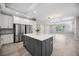 Bright, open kitchen boasts stainless appliances, a spacious island, and views into the open living area at 5018 Hanging Moss Ln, Sarasota, FL 34238