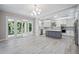 Open-concept kitchen with stainless appliances, an island, and ample counter space at 5018 Hanging Moss Ln, Sarasota, FL 34238
