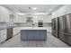 Modern kitchen featuring white cabinets, stainless steel appliances, and a large island at 5018 Hanging Moss Ln, Sarasota, FL 34238