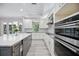 Well-equipped kitchen with center island, sleek appliances, and contemporary design at 5018 Hanging Moss Ln, Sarasota, FL 34238