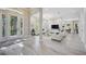 Open-concept living room with a clear view of the front entrance and abundant natural light at 5018 Hanging Moss Ln, Sarasota, FL 34238