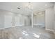 Large living room area featuring tile floors, modern lighting, and an open layout at 5018 Hanging Moss Ln, Sarasota, FL 34238