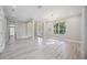 Spacious living room featuring neutral tones, wood floors, recessed lighting, and an abundance of natural light at 5018 Hanging Moss Ln, Sarasota, FL 34238