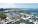 Panoramic aerial view of waterfront marina featuring boats, lush landscaping and commercial buildings at 510 Wedge Ln, Longboat Key, FL 34228