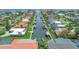 Aerial view showcasing waterfront homes along canal, palm trees, boat docks, and lush landscaping at 510 Wedge Ln, Longboat Key, FL 34228
