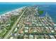 High angle view featuring a canal community near beaches, boats, docks, mature landscaping, and roads at 510 Wedge Ln, Longboat Key, FL 34228