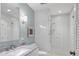 Modern bathroom features a large vanity and a seamless glass shower at 510 Wedge Ln, Longboat Key, FL 34228
