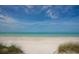 Serene beach featuring pristine white sand and tranquil turquoise water under a clear blue sky at 510 Wedge Ln, Longboat Key, FL 34228