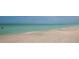 Picturesque beach view with gentle waves meeting the sandy shore, creating a tranquil seaside escape at 510 Wedge Ln, Longboat Key, FL 34228