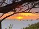 Gorgeous beach view with a vibrant sunset, silhouetted figures, and peaceful sandy shore at 510 Wedge Ln, Longboat Key, FL 34228
