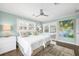Cozy bedroom with matching decor features a slider with pool views and natural light at 510 Wedge Ln, Longboat Key, FL 34228