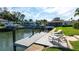 Boat dock in the canal with lounge chairs on a sunny day provides relaxation and waterfront living at 510 Wedge Ln, Longboat Key, FL 34228