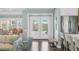Bright foyer features hardwood floors, a bench, and views of the front yard through double doors at 510 Wedge Ln, Longboat Key, FL 34228