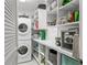 Well-organized laundry room boasts washer, dryer, storage, and shelving at 510 Wedge Ln, Longboat Key, FL 34228