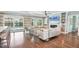 Open living room with modern furnishings, a fireplace, and sliding doors to the pool area at 510 Wedge Ln, Longboat Key, FL 34228
