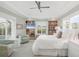 Bright primary bedroom featuring built-in bookcases and sitting area at 510 Wedge Ln, Longboat Key, FL 34228