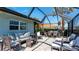 Inviting screened patio with comfortable seating and dining area, perfect for outdoor living at 510 Wedge Ln, Longboat Key, FL 34228