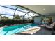 Beautiful pool features a screened-in enclosure and lounge chairs at 510 Wedge Ln, Longboat Key, FL 34228