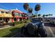 Charming street view with vintage car, local shops and mature palm trees at 510 Wedge Ln, Longboat Key, FL 34228