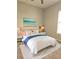 Serene bedroom with a plush bed, soft lighting, and beach-themed artwork, creating a relaxing retreat at 5146 Northridge Rd # 310, Sarasota, FL 34238