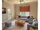Cozy living room with comfortable seating, bright natural light, and complemented by elegant crown molding at 5146 Northridge Rd # 310, Sarasota, FL 34238