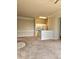 Cozy living room featuring neutral paint, breakfast bar, and tan carpet, perfect for relaxation and everyday living at 5146 Northridge Rd # 310, Sarasota, FL 34238