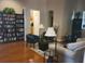 Cozy living room featuring hardwood floors, stylish furnishings, and a bookshelf at 5146 Northridge Rd # 310, Sarasota, FL 34238