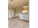 Inviting living room featuring plush carpet and a convenient breakfast bar to the kitchen with white cabinets and appliances at 5146 Northridge Rd # 310, Sarasota, FL 34238