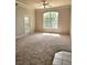 Bright living room with large windows, balcony access, and neutral carpet, creating a comfortable and inviting space at 5146 Northridge Rd # 310, Sarasota, FL 34238