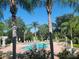 Community pool area with palm trees and plenty of seating for residents to enjoy on sunny days at 5146 Northridge Rd # 310, Sarasota, FL 34238
