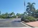 Street view with mature trees and landscaping and an American Flag; community in a park-like setting at 5146 Northridge Rd # 310, Sarasota, FL 34238
