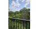 Scenic view from balcony showing lush greenery and a vibrant blue sky filled with fluffy clouds at 5146 Northridge Rd # 310, Sarasota, FL 34238