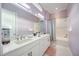 Elegant bathroom with a large mirror, double sinks, and a shower-tub combination at 5328 Brookgrove Dr, Sarasota, FL 34238