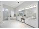 Bright bathroom featuring a soaking tub, glass shower, granite counters, and dual sink vanity with ample storage at 5328 Brookgrove Dr, Sarasota, FL 34238