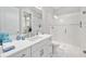 Bright bathroom features tiled shower and vanity with large mirror and storage at 5328 Brookgrove Dr, Sarasota, FL 34238