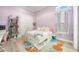 Charming bedroom with lilac walls, a bookcase, desk, and platform bed featuring built-in storage at 5328 Brookgrove Dr, Sarasota, FL 34238