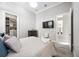 Well-lit bedroom with en-suite bathroom, TV, and walk-in closet at 5328 Brookgrove Dr, Sarasota, FL 34238