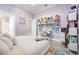 Bright bedroom with shelving, desk, and light purple walls and flooring at 5328 Brookgrove Dr, Sarasota, FL 34238