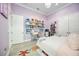 Bright bedroom with shelving, desk, and neutral walls and carpeting at 5328 Brookgrove Dr, Sarasota, FL 34238