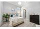 This cozy bedroom offers soft natural light, a decorative chandelier, and soft decor at 5328 Brookgrove Dr, Sarasota, FL 34238