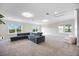 Large bonus room with carpet, comfortable sectional sofa, and lots of natural light at 5328 Brookgrove Dr, Sarasota, FL 34238