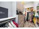 Walk-in closet with custom shelving, cabinets, drawers, and hanging racks for optimal organization and style at 5328 Brookgrove Dr, Sarasota, FL 34238