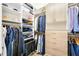Walk-in closet with custom shelving, cabinets, drawers, and hanging racks for optimal organization and style at 5328 Brookgrove Dr, Sarasota, FL 34238