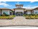 Beautiful clubhouse exterior with lush landscaping and decorative stone accents, showcasing a welcoming entrance at 5328 Brookgrove Dr, Sarasota, FL 34238