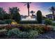 Entrance to Legacy Estates shows manicured landscaping and lighting, establishing an elegant and welcoming neighborhood at 5328 Brookgrove Dr, Sarasota, FL 34238