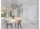 Bright dining room features tile floors, modern chandelier, and outdoor views at 5328 Brookgrove Dr, Sarasota, FL 34238