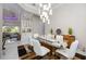 Dining area with a glass-top table, elegant decor, and a clear view to the living room at 5328 Brookgrove Dr, Sarasota, FL 34238