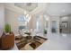 Elegant dining room with tile floors, contemporary lighting, and views of the home's entry at 5328 Brookgrove Dr, Sarasota, FL 34238
